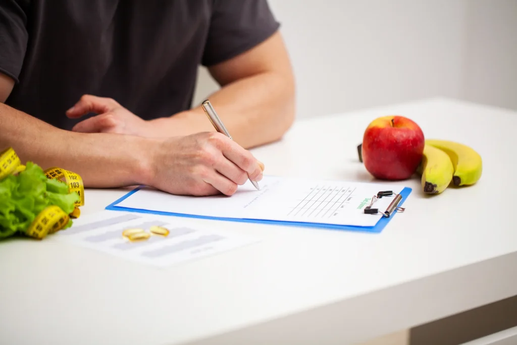 man writes diet plan on white table 2026 03 19 05 15 32 utc